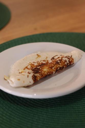 a piece of food on a plate on a table at Pousada Deu Praia Maragogi in Maragogi