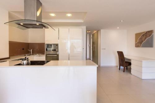 a kitchen with white cabinets and a counter top at Cozy 3BD Seaside Apartment! WiFi and Great Location! in Tal-Għoqod