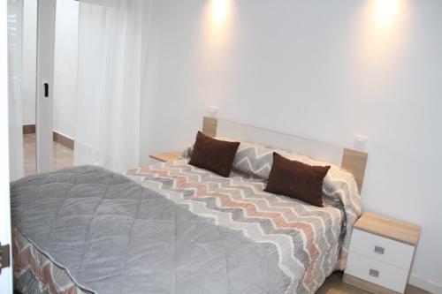 a bedroom with a large bed with two pillows at Los palomares in El Casar de Talamanca