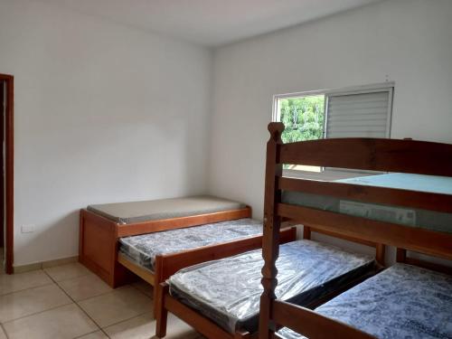 a room with two bunk beds and a window at Casa 11 hóspedes Temporada em Ribeirão in Ribeirão Preto