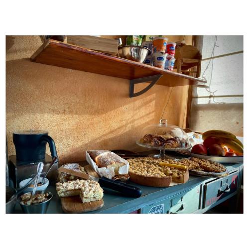 a counter with a bunch of different types of food at Aurelia Garden Gold B&B in Rome