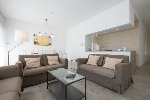 a living room with two couches and a table at Bela Vista da Luz 17 by Destination Algarve in Luz
