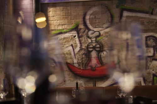 a wall with a painting of a woman on it at Altes Stahlwerk Business & Lifestyle Hotel in Neumünster
