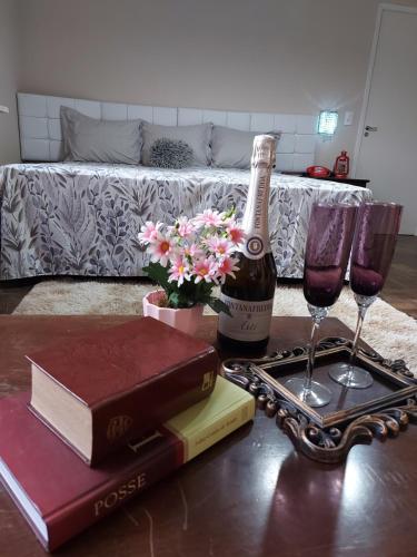 a table with two glasses and a bottle of wine at Hotel Dom Paulo in Lapa