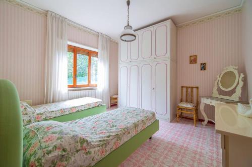 Postel nebo postele na pokoji v ubytování Villa Mimma.