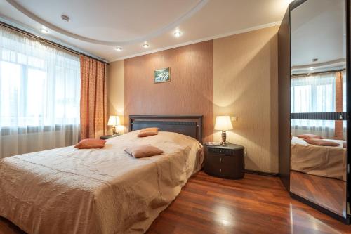a bedroom with a large bed and a window at готель Моряк in Chornomorsk