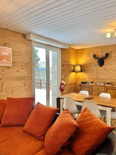 a room with a couch with pillows and a table at Gîte de la Croix d'Egat in Égat