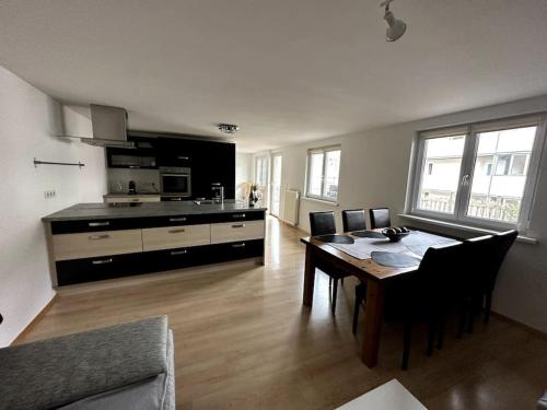 a kitchen and dining room with a table and chairs at Maisonette-Apartment mit großer Terrasse im Zentrum von Bregenz in Bregenz