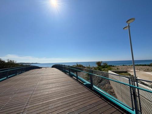 a boardwalk leading to the beach with a street light at Villa Marina Sea-View Private Pool in Peyia