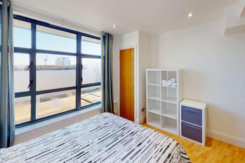 a bedroom with a bed and a large window at City Centre Sleeps up to 6 in Nottingham