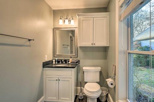 a bathroom with a toilet and a sink and a mirror at 10 Mi to New Braunfels Waterfront Seguin Gem in Seguin