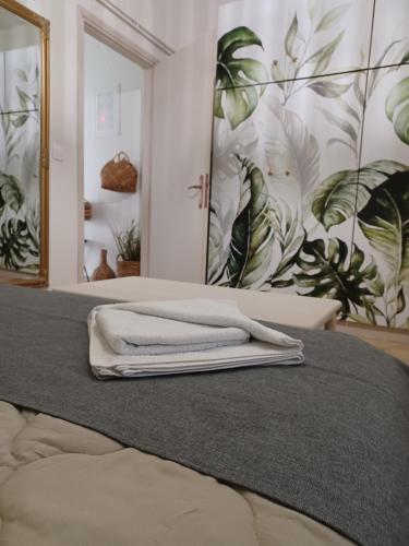 a bedroom with a bed with towels on it at El Nido Apartment in Limenas