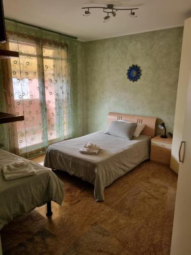 a bedroom with a large bed and a window at Consuelo House in Arzergrande
