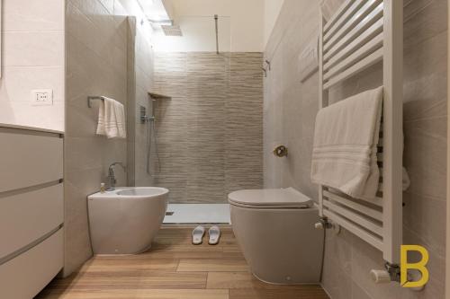a bathroom with a toilet and a sink at BePlace Apartments in Gioia in Milan