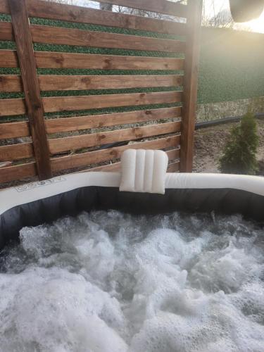 a jacuzzi tub filled with snow in a backyard at Къща за гости Vip House 