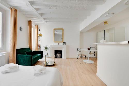 un salon avec un canapé vert et une table dans l'établissement Saint placide cannette, à Paris