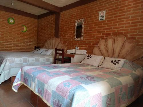 Postel nebo postele na pokoji v ubytování Hotel Villas Kerendarhú