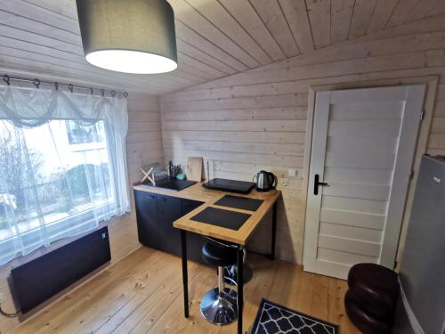 a small room with a desk and a window at Domek Letni in Gdynia