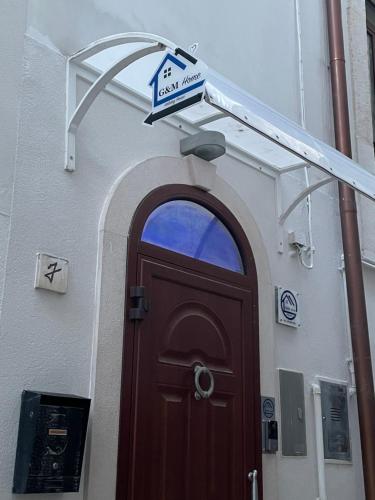 a door to a building with a sign above it at G&M Home in Castellana Grotte