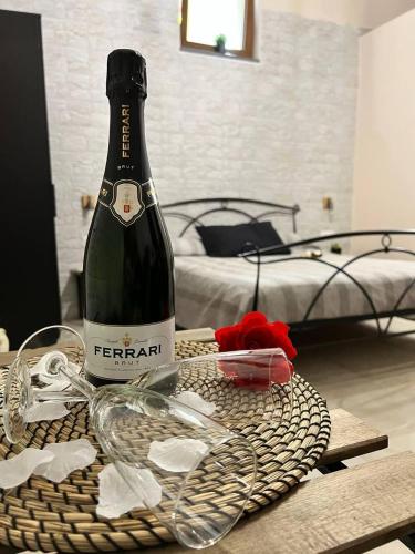a bottle of champagne on a table in a bedroom at Room-Antica in Castellammare di Stabia
