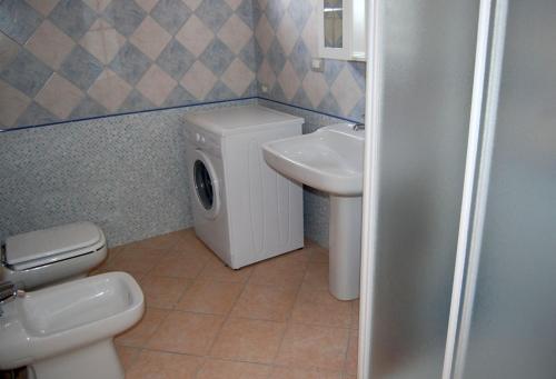 a bathroom with a toilet and a sink at Elegante appartamento dotato di veranda con vista mare Maladroxia C64 in Maladroxia