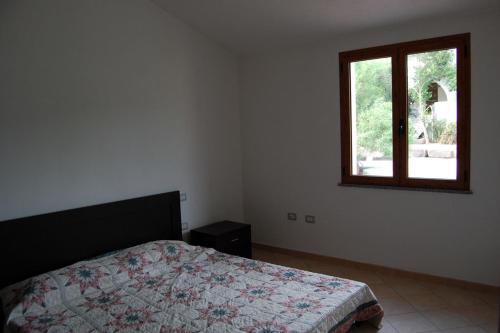 a bedroom with a bed and a window at Elegante appartamento dotato di veranda con vista mare Maladroxia C64 in Maladroscia