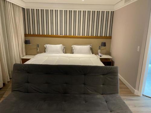 a bedroom with a large bed in a room at Suite Radisson Vila Olimpia in Sao Paulo