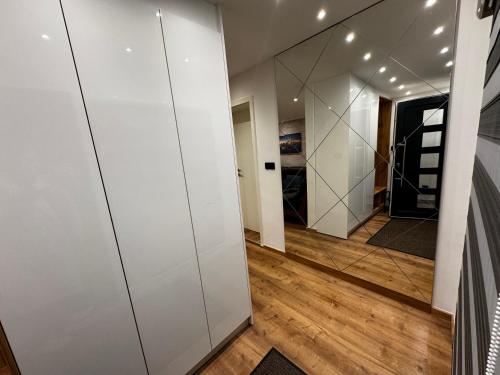 a hallway with white walls and a mirror at Ferienwohnung E in Soltau