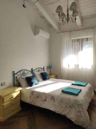 a bedroom with a large bed and a window at Caledonia B&B in Mercato San Severino