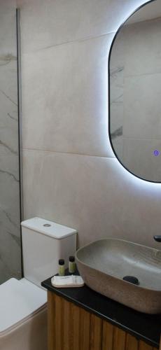 a bathroom with a sink and a mirror at Oniropetra Luxury Suites in Kastéllion
