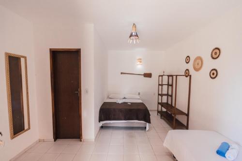 a bedroom with a bed and a ladder in it at Pousada Villa Aruna in Barra Grande
