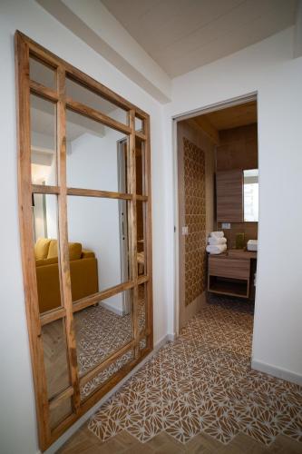 a room with a sliding glass door with a yellow couch at Vecchia Mottola Private Suite & Spa in Mottola