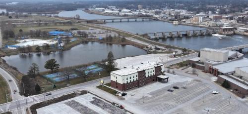 an aerial view of a city with a river at Cobblestone Hotel & Suites - Ottumwa in Ottumwa