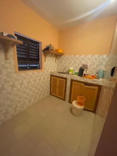 a small kitchen with a sink and a counter at Diabir in Ziguinchor