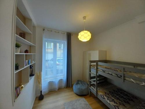 a bedroom with a bunk bed and a window at Appartement de charme 1h de Paris in Coulommiers