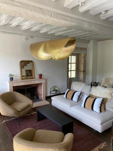 a living room with two couches and a fireplace at La SAURA in Lusigny-sur-Ouche