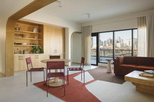a living room with a couch and a table and chairs at Drift Nashville, a Member of Design Hotels in Nashville