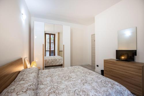 a bedroom with a large bed and a television at Casa Malu' in Legnano