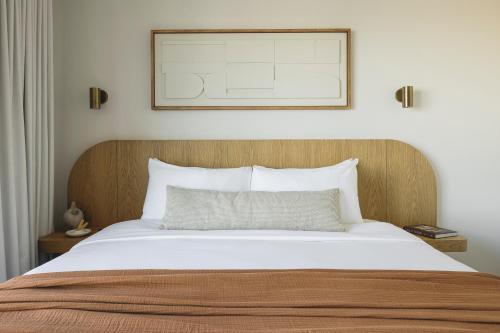 a bedroom with a bed with a picture on the wall at Drift Nashville, a Member of Design Hotels in Nashville