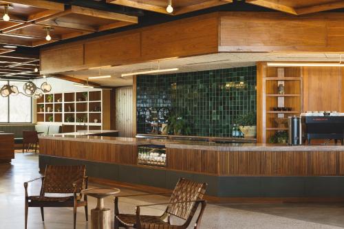 a restaurant with chairs and a bar with green tiles at Drift Nashville, a Member of Design Hotels in Nashville