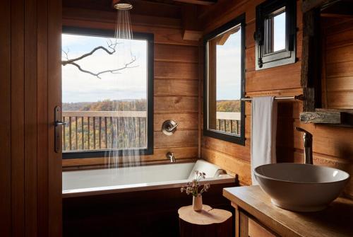 a bathroom with a tub and a sink and a window at The Lodge at Primland, Auberge Collection in Meadows of Dan