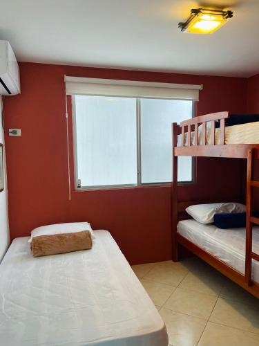 a bedroom with two bunk beds and a window at Casa con piscina súper bonita ! in Salinas