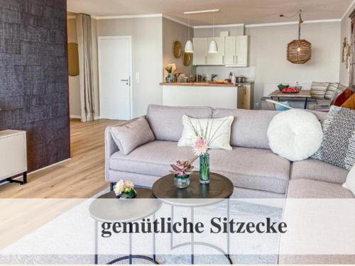 a living room with a couch and a table at Premium Ferienwohnung mit Meerblick in Timmendorfer Strand