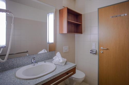 a bathroom with a sink and a toilet at Feriendorf am Maltschacher See in Feldkirchen in Kärnten