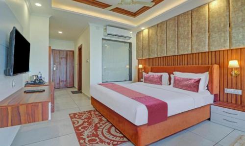 a bedroom with a large bed and a television at Old Bhardwaj guest house Inn Bodhgaya in Gaya