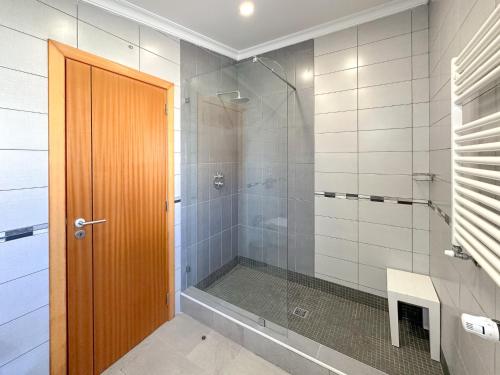 a bathroom with a shower and a glass door at Villa Primavera in Lagos