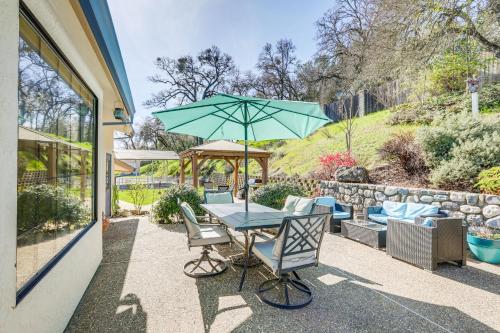 a table and chairs with an umbrella on a patio at Pet-Friendly Jackson Wine Country Home with Pool! in Jackson