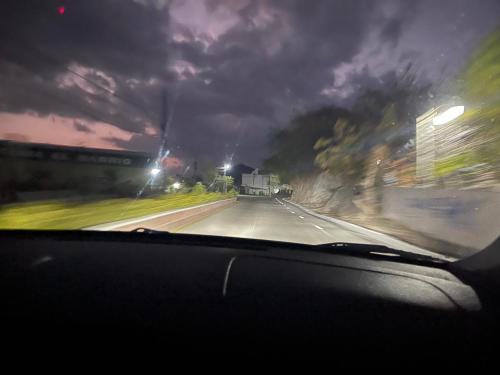 a view from a car windshield of a highway at night at Vangau in Esquipulas