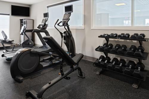 a gym with several treadmills and exercise bikes at Holiday Inn Express Hotel & Suites Brattleboro by IHG in Brattleboro