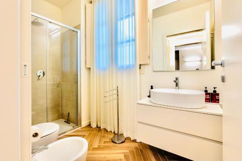 a white bathroom with a sink and a shower at residenza luxury in pieno centro storico in Iseo